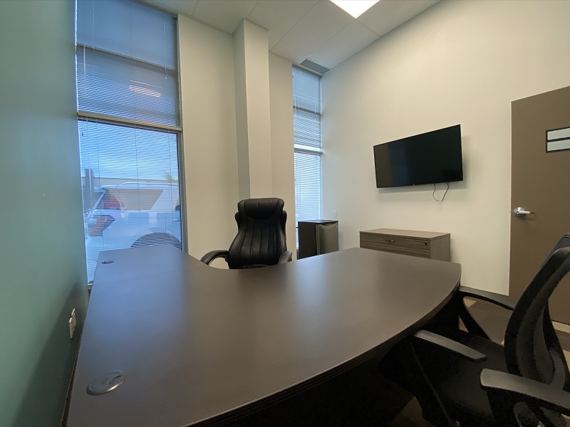 Window, Desk and TV View of Office 21 in the EYE For Business Center